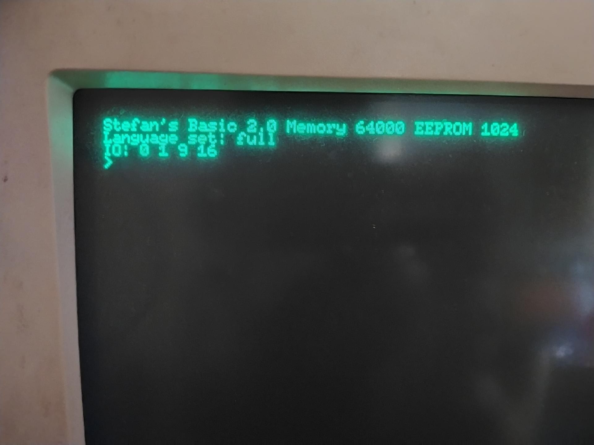 A green phosphorescent CRT monitor reads the Stefan's Tiny BASIC prompt.